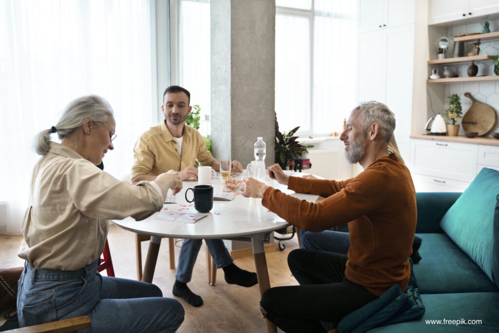 Jung udn Alt am Küchentisch, spielend